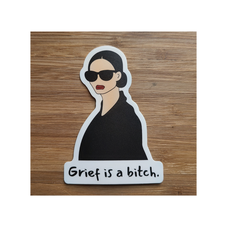 Chic woman in shades above the words "Grief is a bitch". Snarky sticker by Deathday Cards